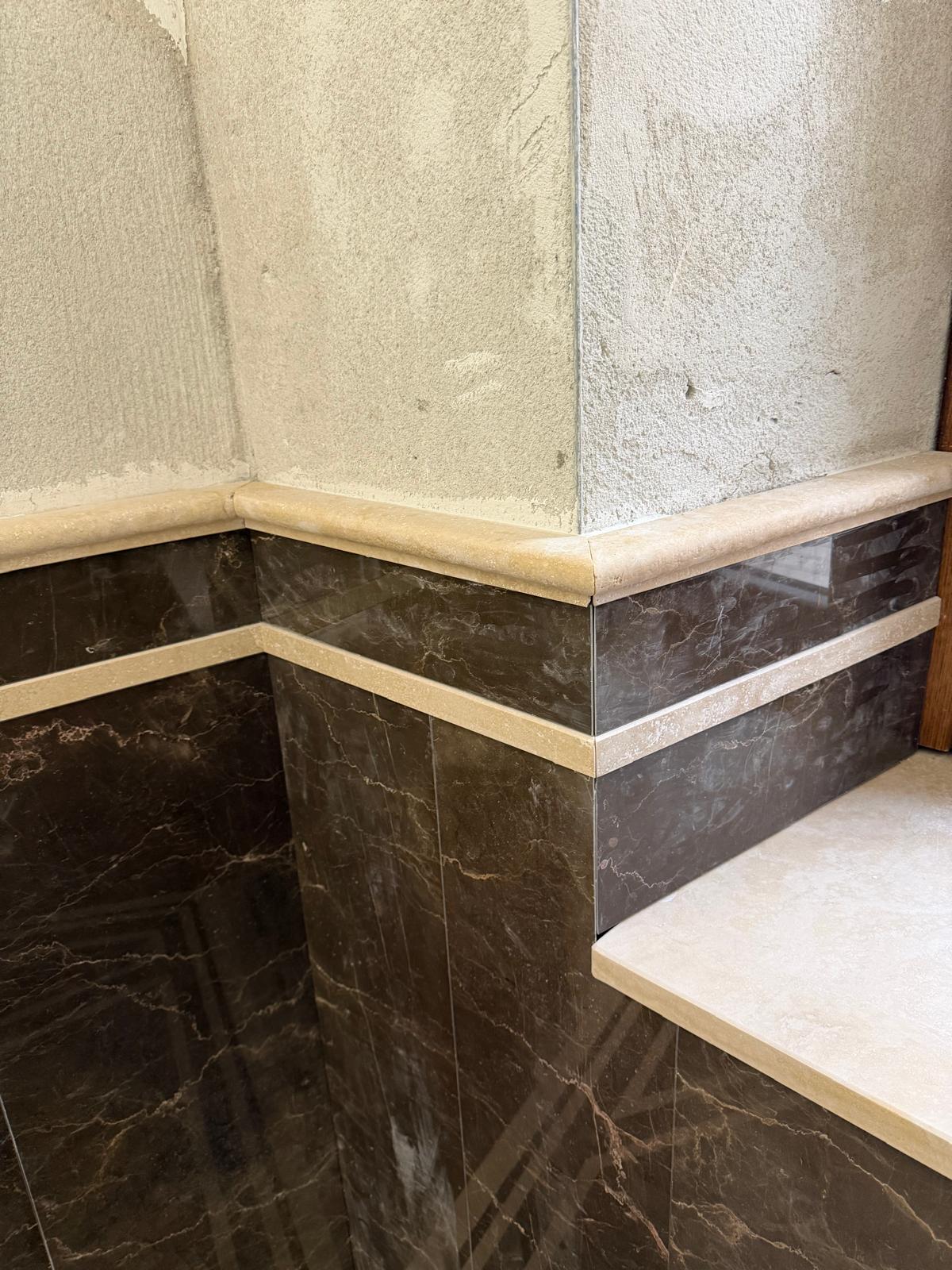 Detail of Emperador marble bathroom cladding